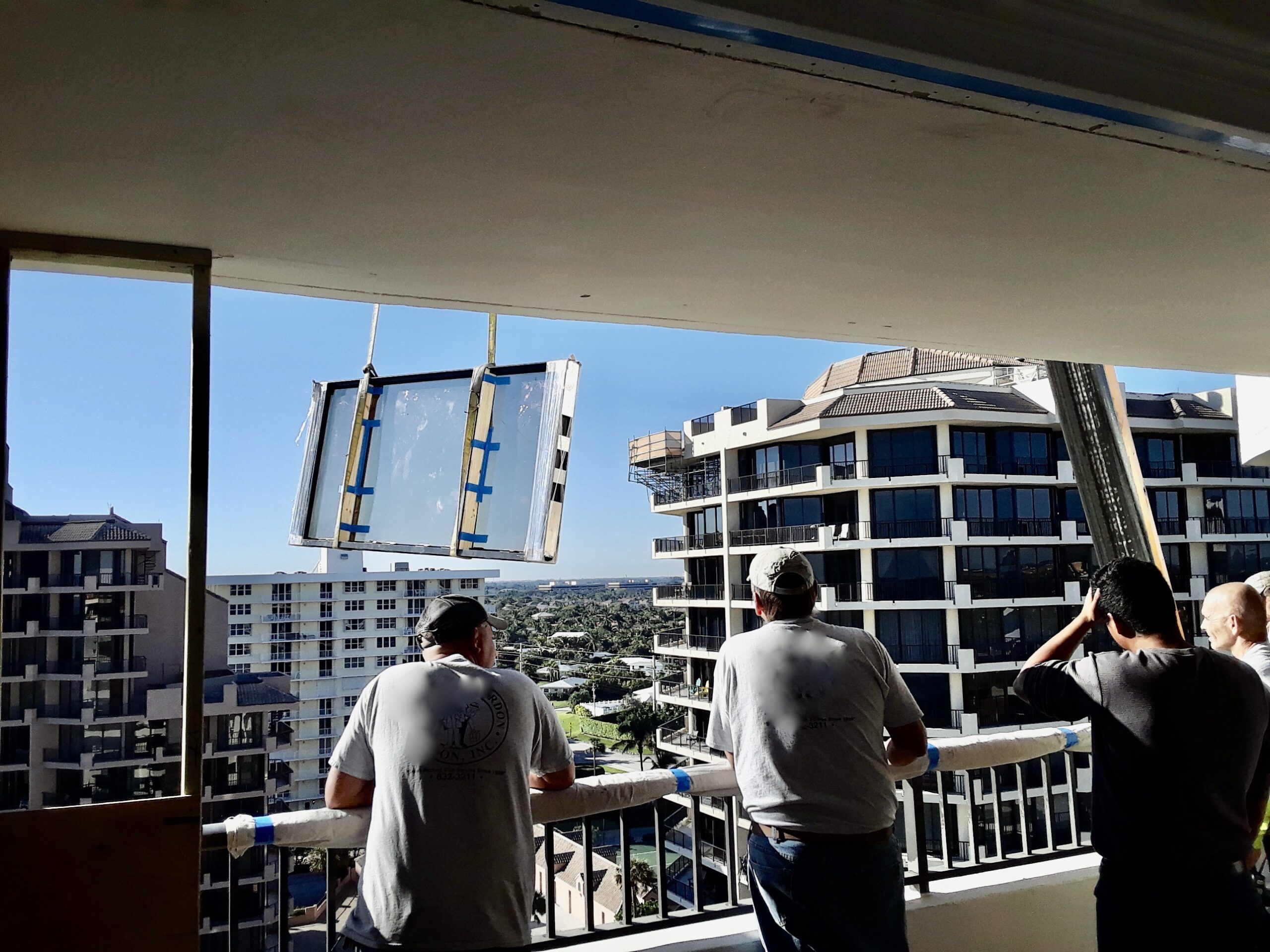Workers preparing to receive the equipment from the crane