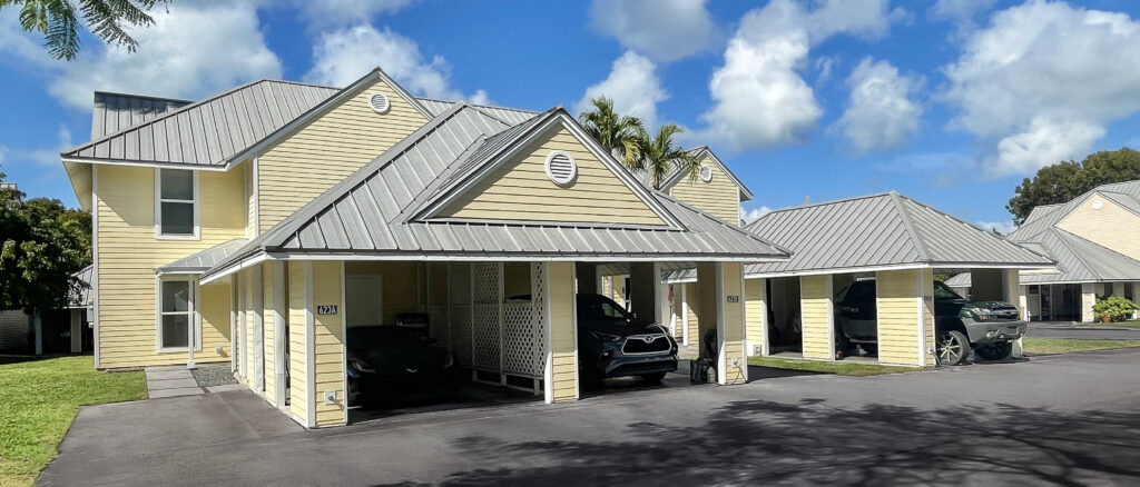 A house with multiple garages with cars