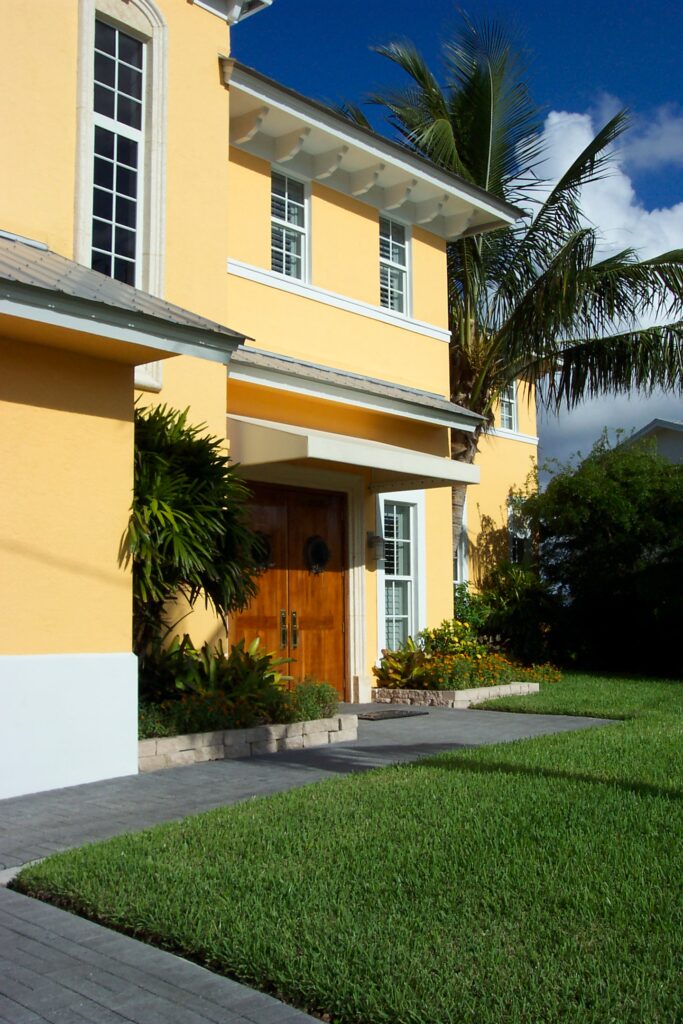 Close up look of the front door of the two storey building with a coconut tree