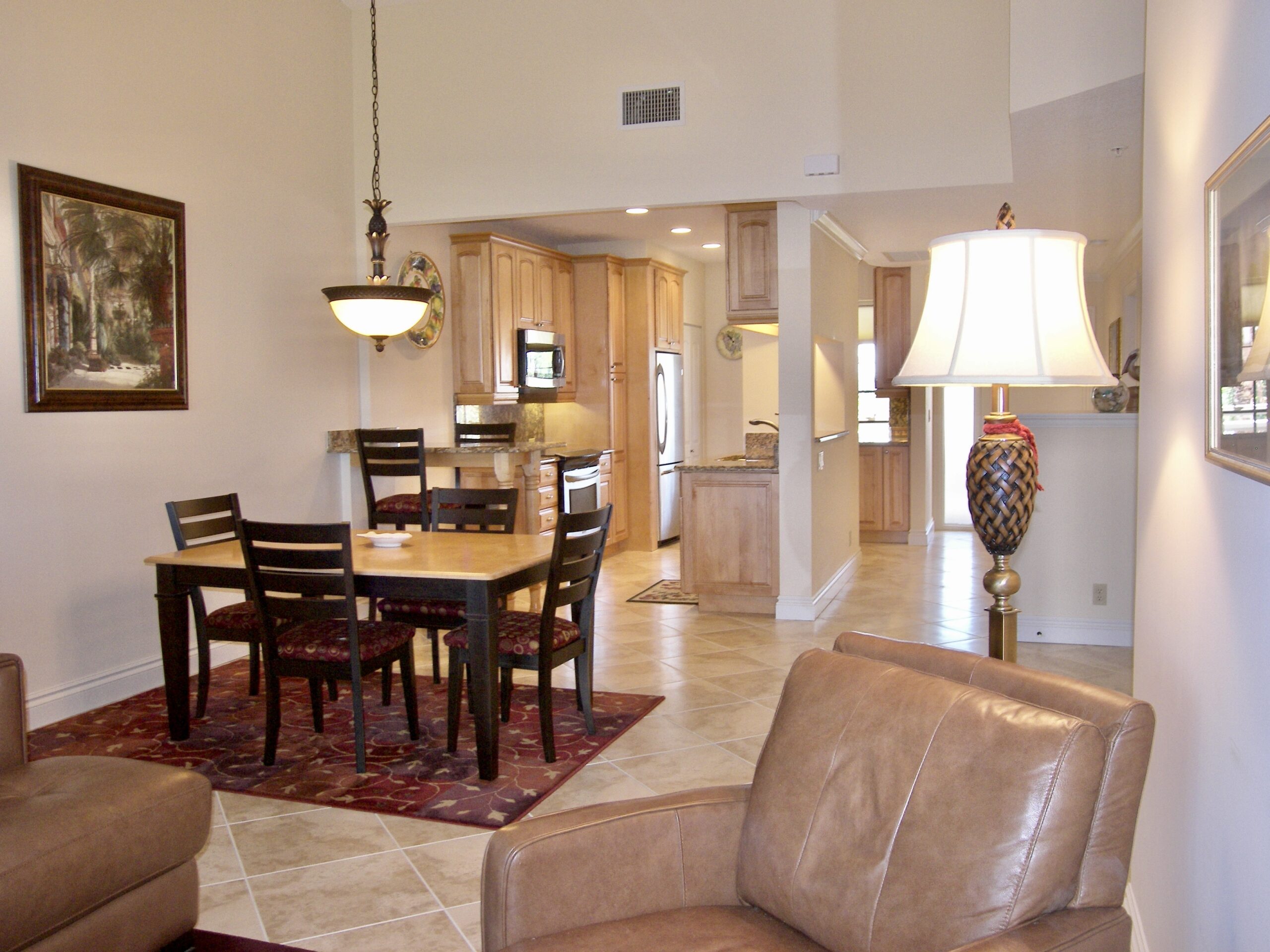 A dining area kitchen with hanging and standing lamps