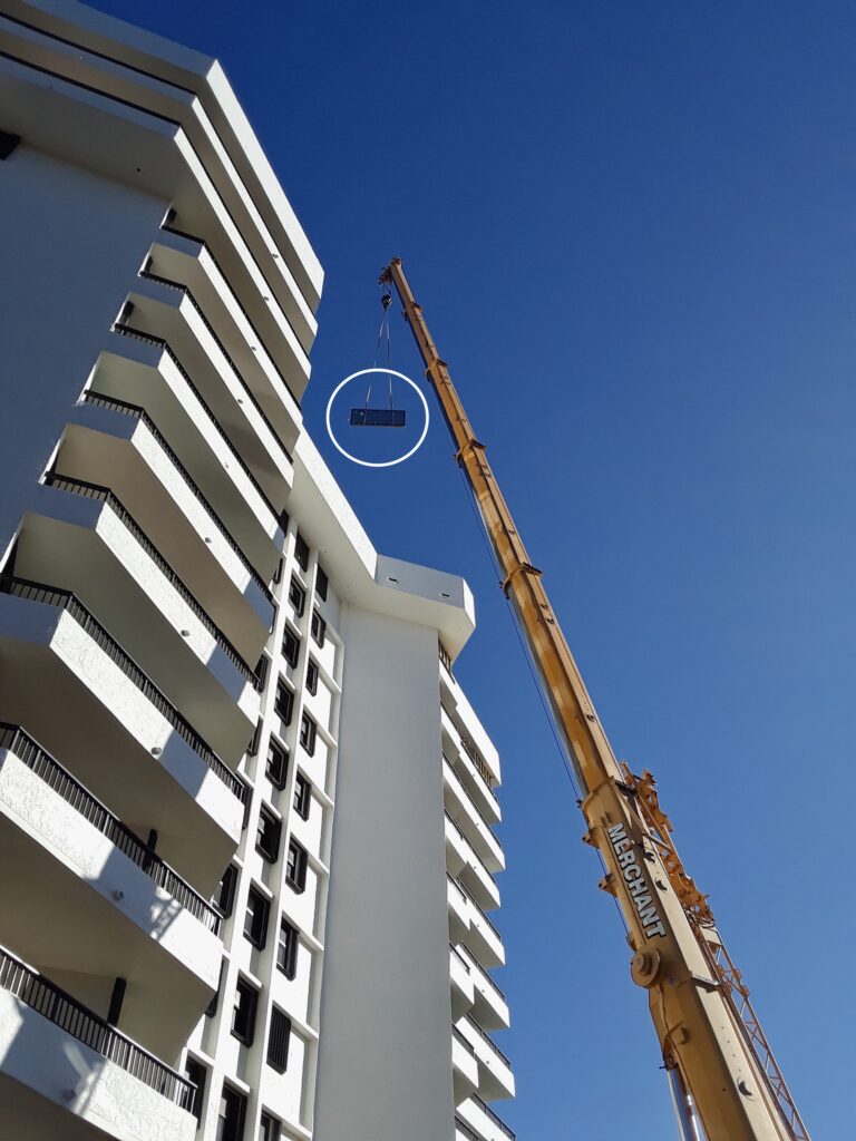 Crane transporting equipment to the building home